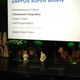 Hsieh, left, and longtime Zappos executive Fred Mossler explain the company’s transition to Holacracy at a Zappos all-hands meeting in November 2013. Employees were told the company would no longer have traditional managers and that everyone would be expected to operate more like entrepreneurs, both catalysts to self-organization.